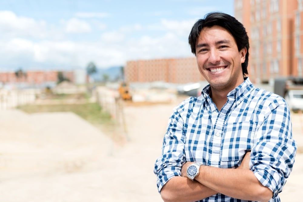 Man at a construction site looking very happy