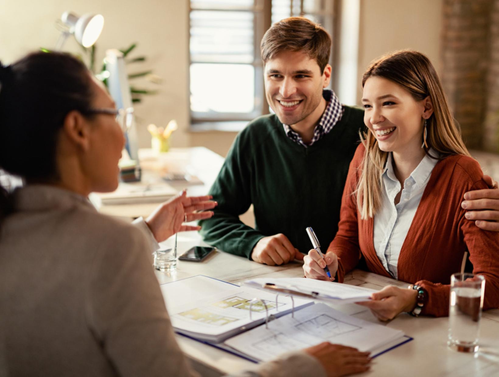 Happy-couple-signing-mortgage-contract